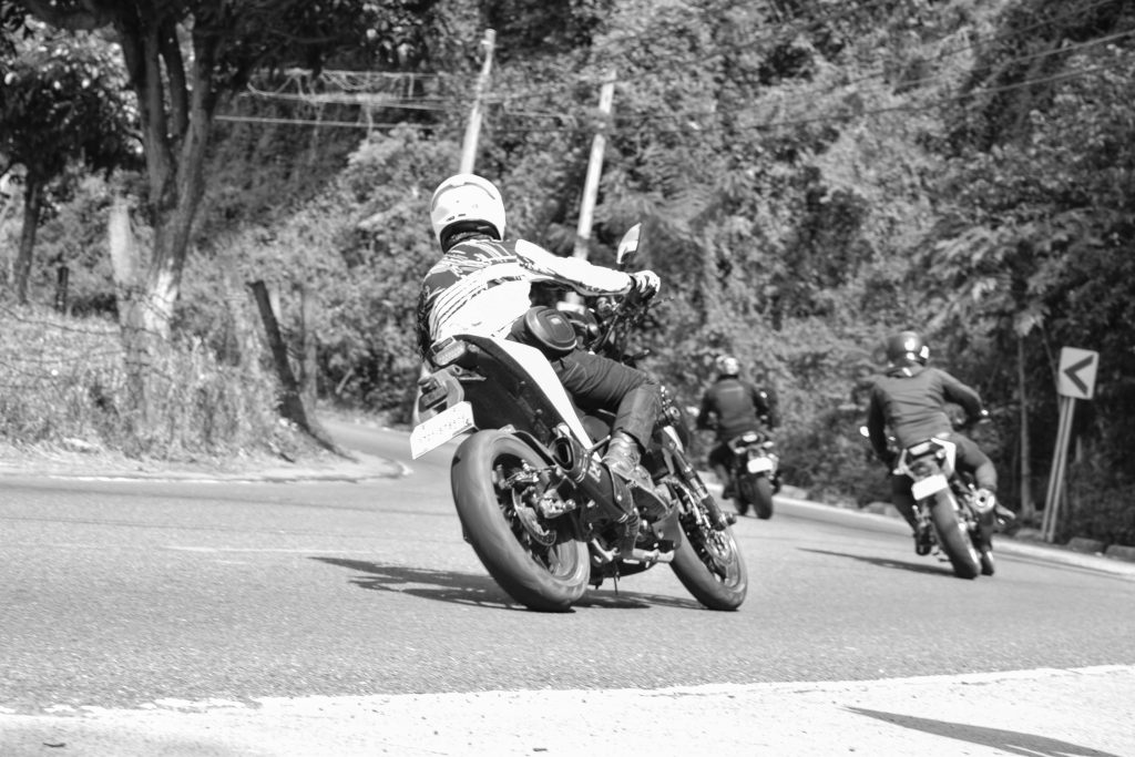 Riders cruising through scenic Black Hills during Sturgis Motorcycle Rally
